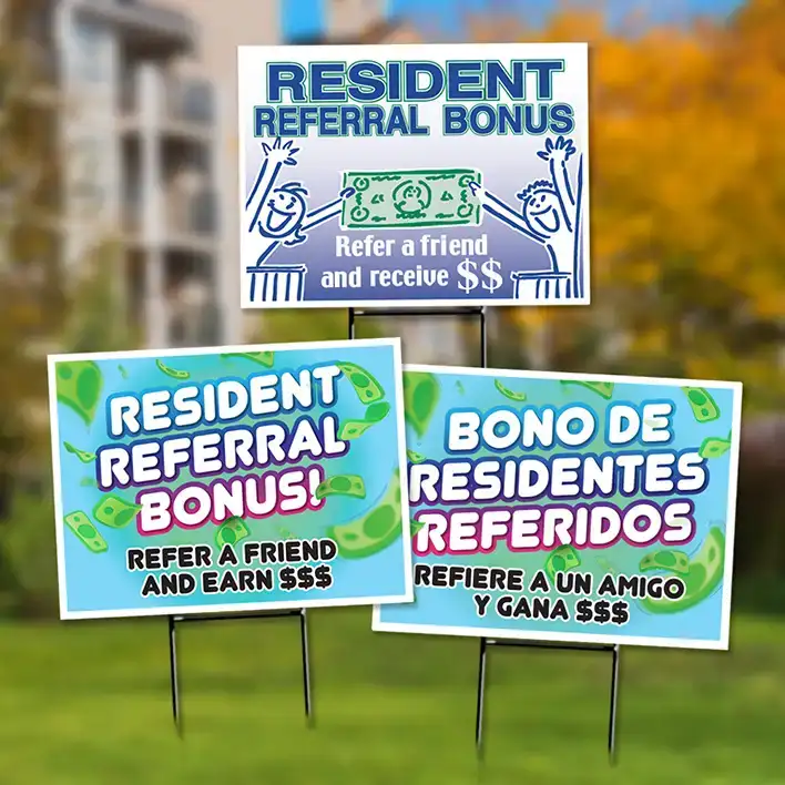 Bandit signs with referral reward messages in front of an apartment office.
